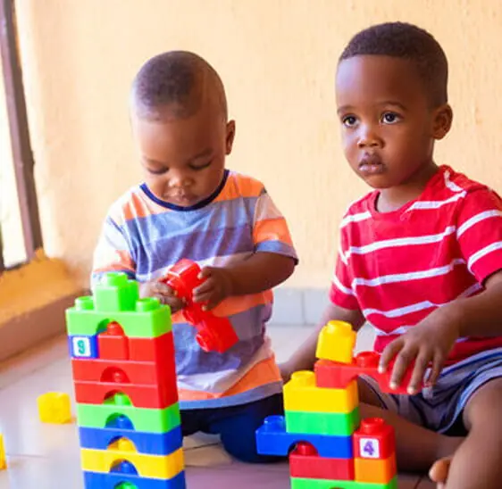 Nursery children playing with building blocks